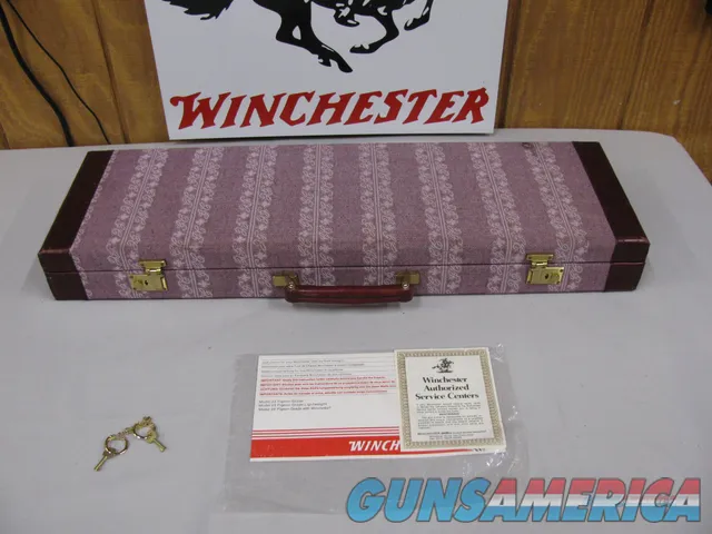 7739 Winchester 23 Grand Canadian 20 gauge 3 inch chambers, 26 inch barrels, beaver tail, ic/mod, vent rib, gold single select trigger, ejectors, 2 white beads,fleur-des-lies checkered side panels,99.9% condition with correct case and paper