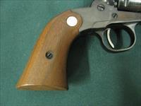 6884  MINT RUGER BEARCAT 22 caliber SINGLE ACTION 4 REVOLVER Serial number 91-48640.EARLY ONE WITH STEEL FRAME- new condition with 100% original blue overall. Factory wood grip panels. No drag line. Does not appear ever shot. Mint screws.  Img-3