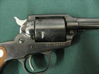 6884  MINT RUGER BEARCAT 22 caliber SINGLE ACTION 4 REVOLVER Serial number 91-48640.EARLY ONE WITH STEEL FRAME- new condition with 100% original blue overall. Factory wood grip panels. No drag line. Does not appear ever shot. Mint screws.  Img-4