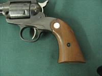 6884  MINT RUGER BEARCAT 22 caliber SINGLE ACTION 4 REVOLVER Serial number 91-48640.EARLY ONE WITH STEEL FRAME- new condition with 100% original blue overall. Factory wood grip panels. No drag line. Does not appear ever shot. Mint screws.  Img-5